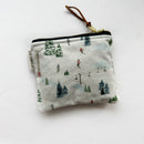 Small square pouch in white winter ski slopes