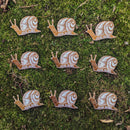 Iron-on patch | slow down snail - brown 1.6" x 2.6": Patch attached to backer card