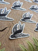 Iron-on patch | flying bird - black & white 3.5" x 2.5": Patch attached to backer card